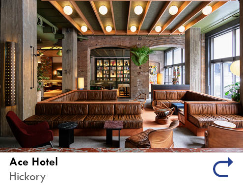 link to the Ace Hotel project feature by the Australian National Construction Review. Image shows the interior lobby of the Ace Hotel in Sydney, with brick walls, leather sofas and high ceilings with timber details.